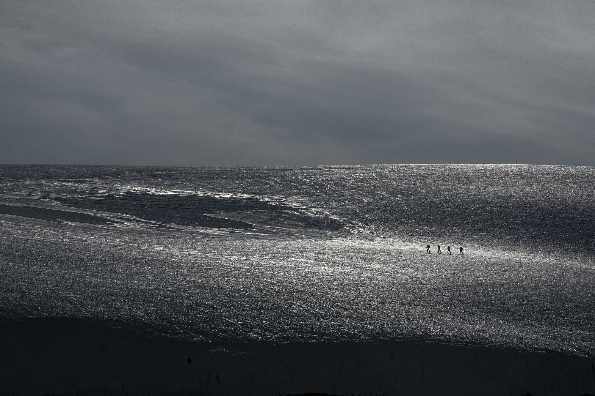 A group of tourists walk across an ice field in Antarctica, 2013, Martin Hartley