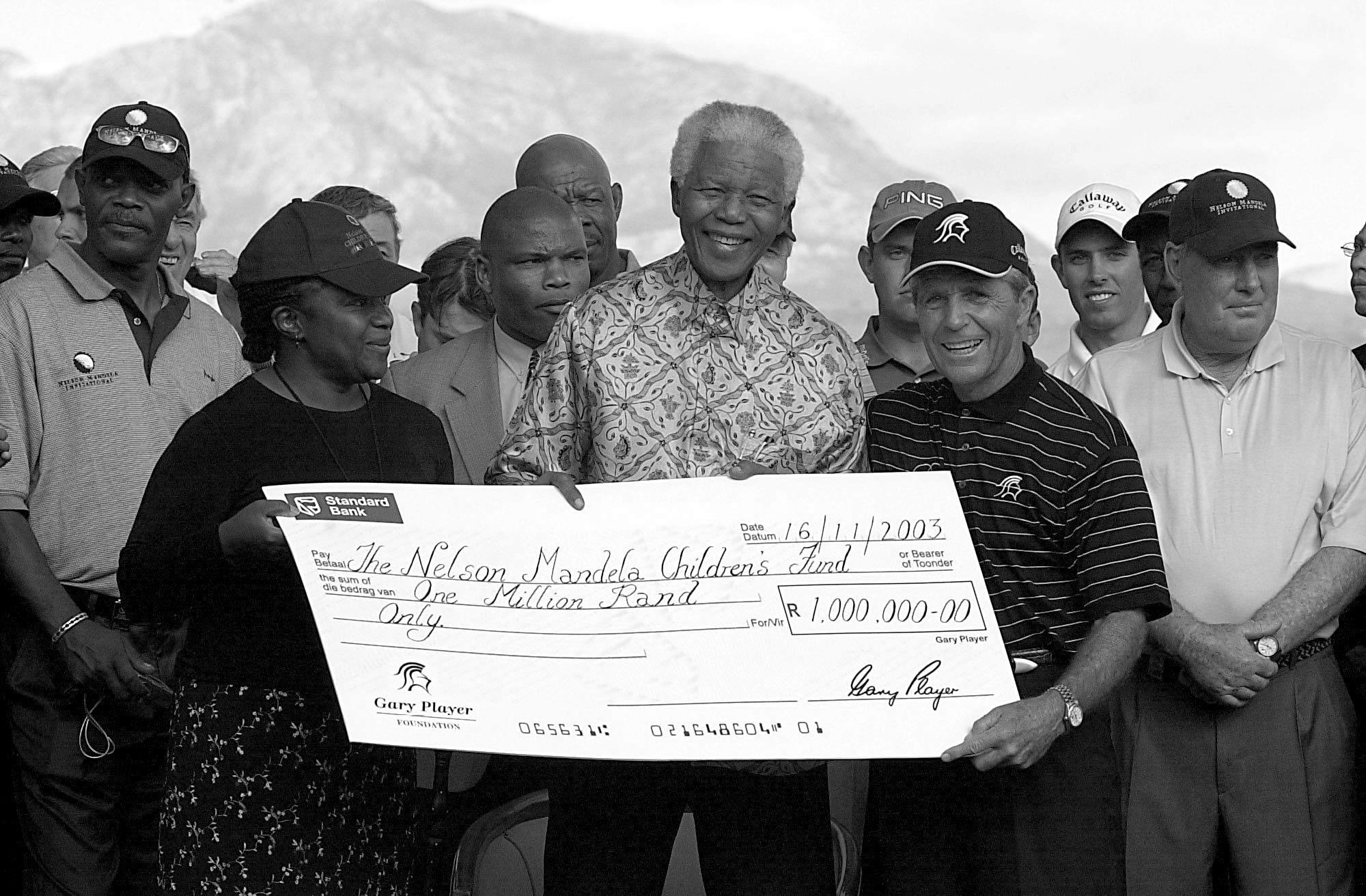 Gary Player presenting a donation to Nelson Mandela