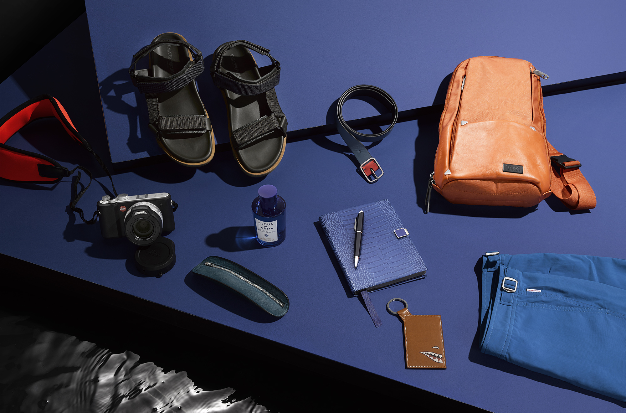 Clockwise from left X-U underwater camera, £2,770, LEICA; sandals, £340, EMPORIO ARMANI; belt, £95, PAUL SMITH; sling bag, £245, TUMI; Dane II shorts, £145, ORLEBAR BROWN; luggage tag, £650, HERMÈS; Soho notebook, £165, SMYTHSON; AD Fighter pen, £250, DUNHILL; Cedro di Taormina eau de toilette, £93 for 150ml, ACQUA DI PARMA; small surf case in Epsom calfskin, £480, HERMÈS