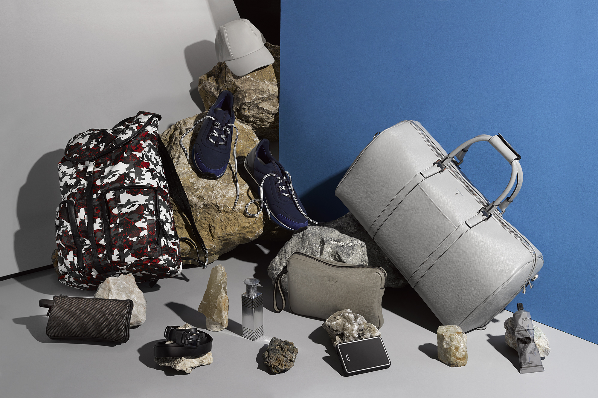 On the rocks: Clockwise from top: Cap, £590, and sneakers, £690, both HERMÈS; bag, £1,040, SERAPIAN; Redemption body scrub, 180ml for £25, AESOP; powerbank, £85, TUMI; bag, £125, DAKS; Versilia Platinum eau de parfum, £198 for 100ml, PROFUMI DEL FORTE at Fenwick of Bond treet; belt, £140, TROUBADOUR; Pelle Tessuta pouch, £580, ERMENEGILDO ZEGNA; backpack, £420, MARCELO BURLON