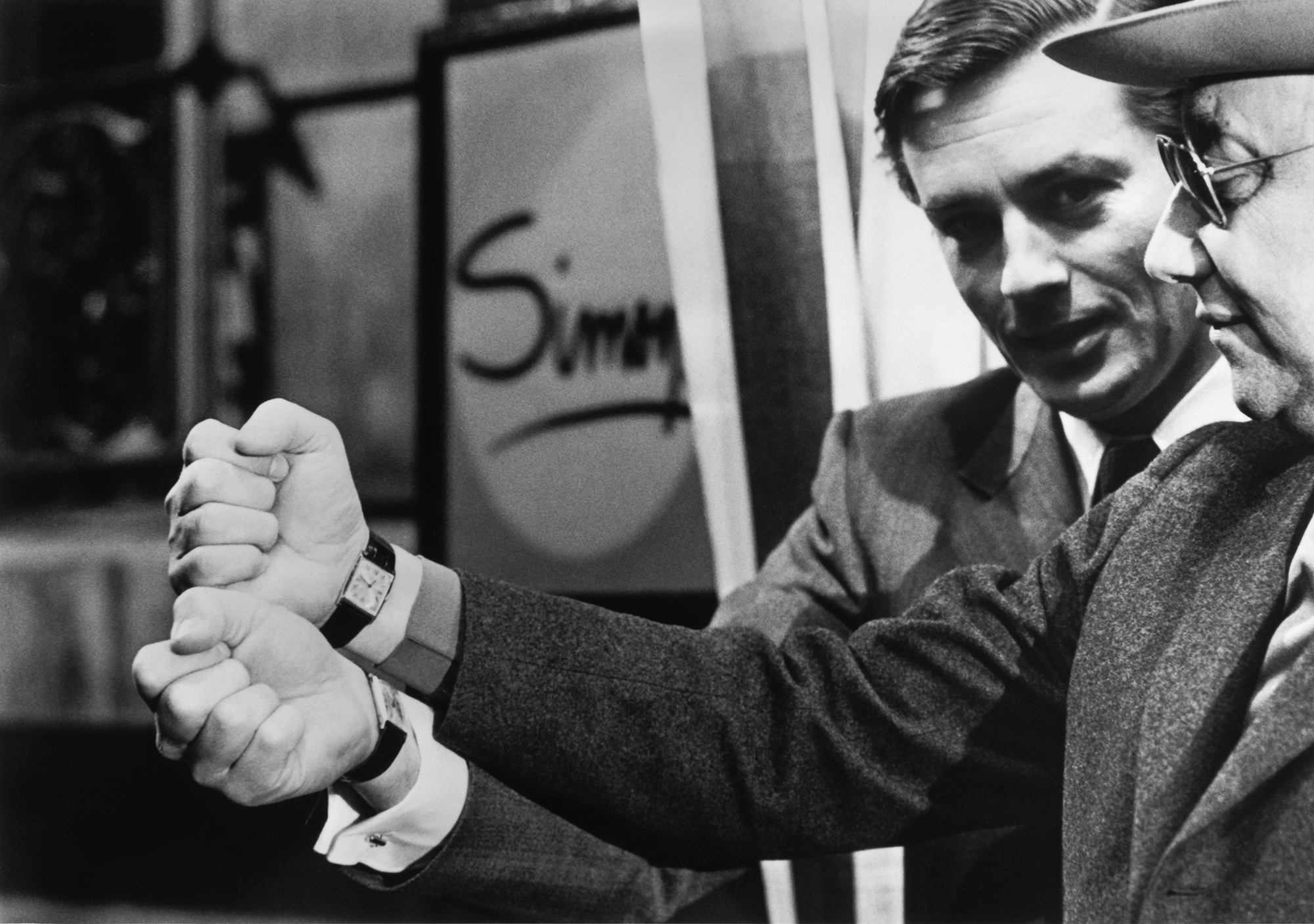 Alain Delon and Jean-Pierre Melville, both wearing the Cartier Tank watch that turns 100 this year