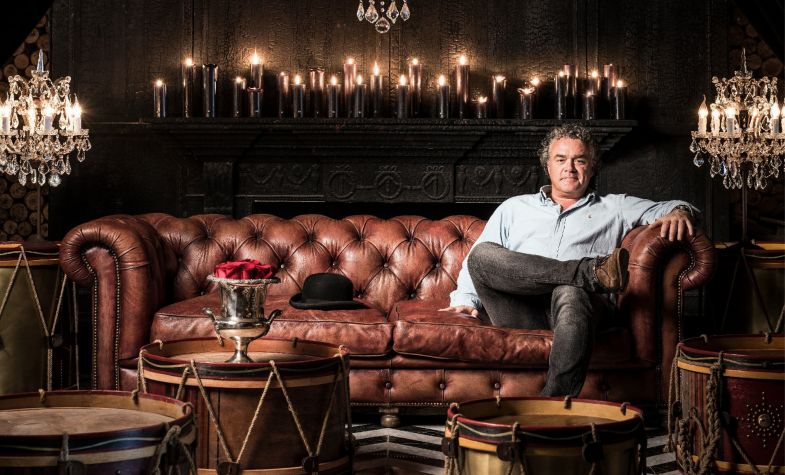 Interior designer Timothy Oulton relaxes on a Chesterfield