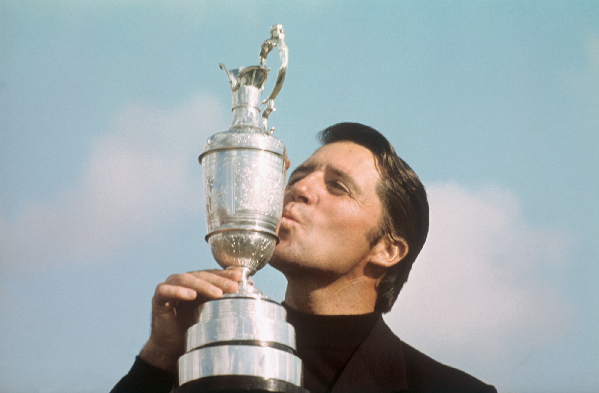 Player kissing his British Open Championship trophy in July 1974