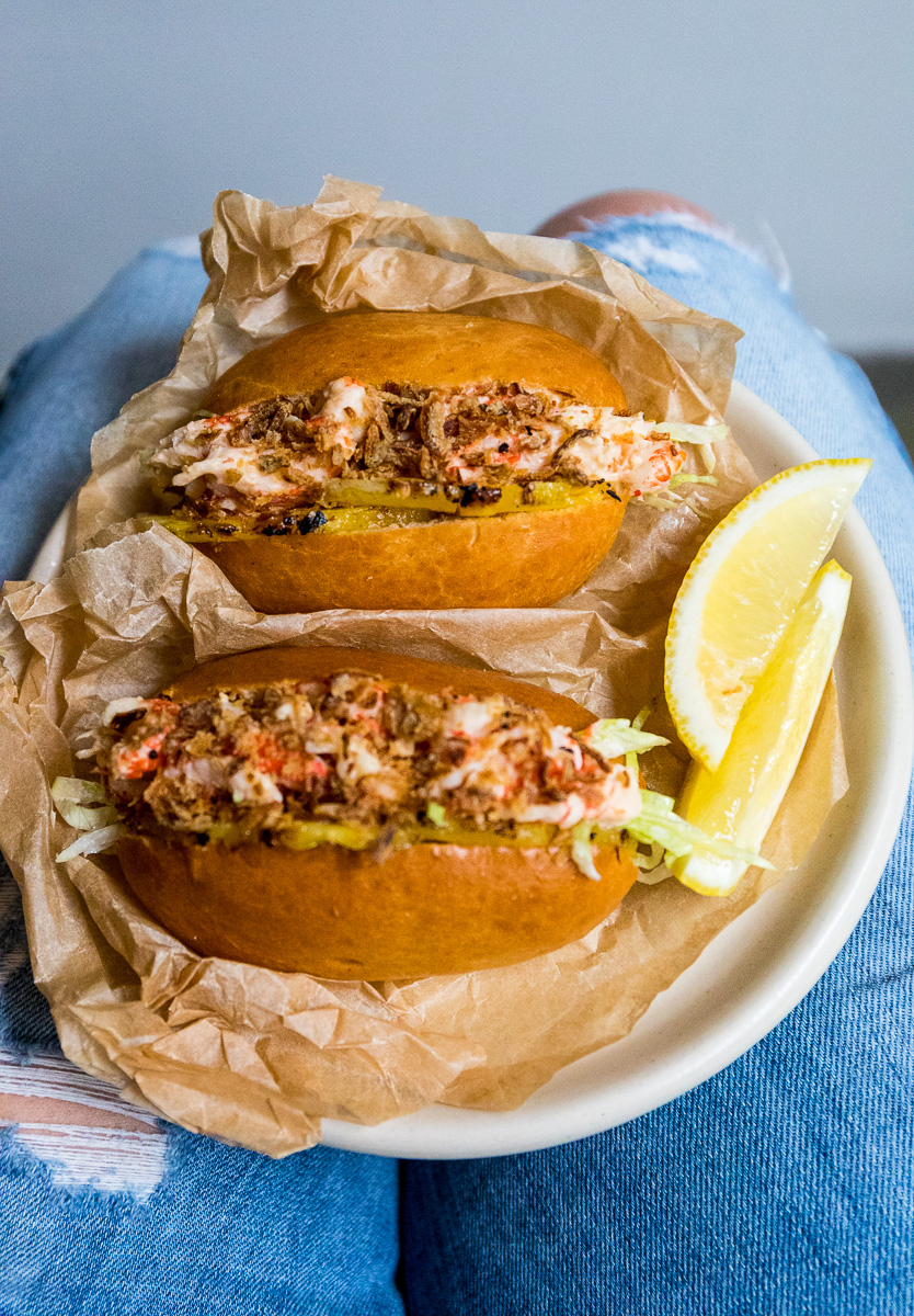 Shrimp roll with grilled pineapple, cocktail sauce and crispy onions