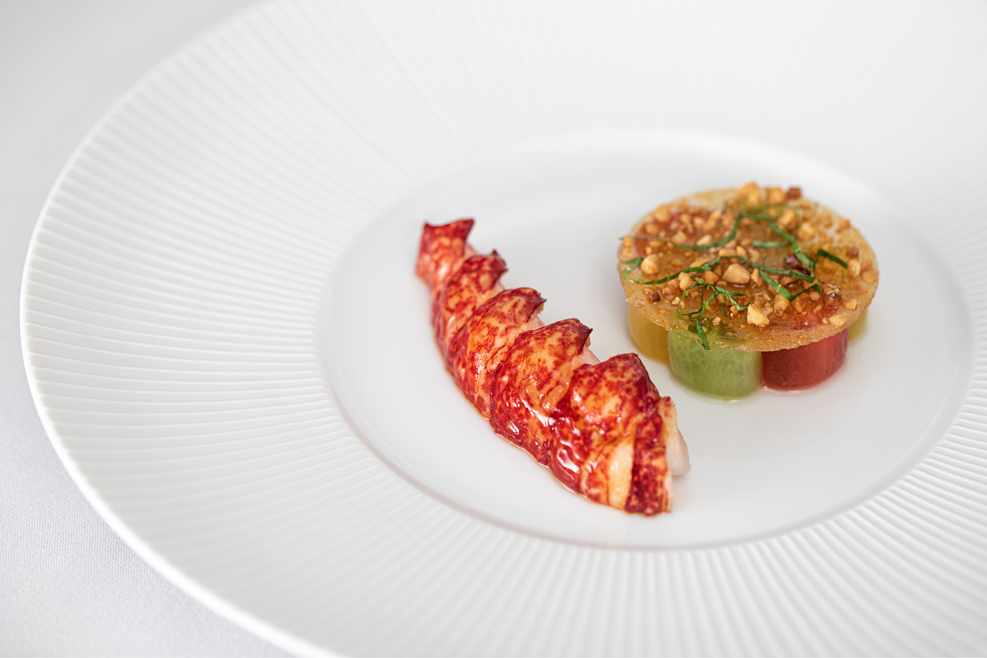 Poached native lobster with Isle of Wight tomato, pine nut and basil, one of the signature dishes at Ormer Mayfair by Sofian