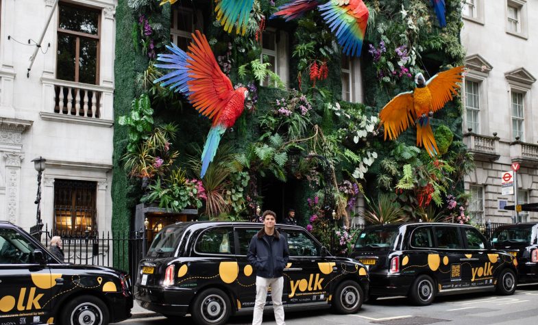 Bernardo Braga with a fleet of Yolk-adorned black cabs in Berkeley Square this summer