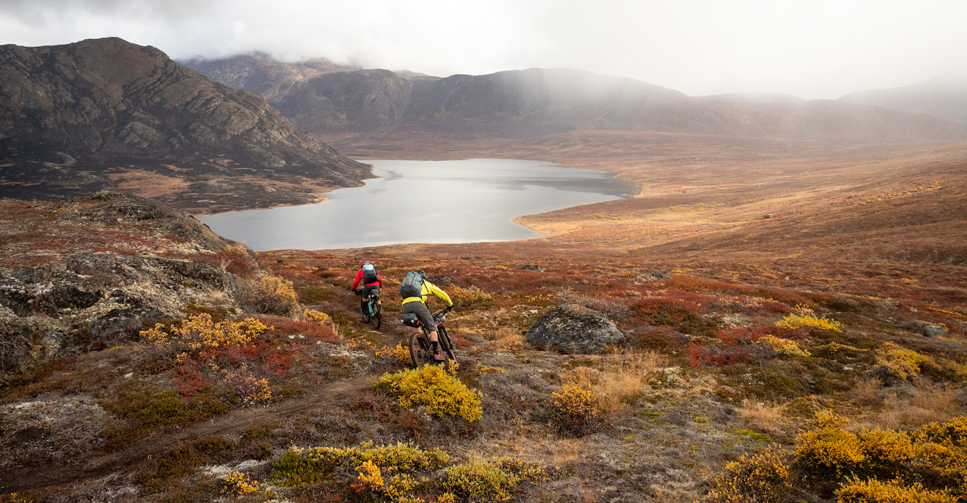 Mountain bikers descending in Greenland on an adventure with Joro Experiences