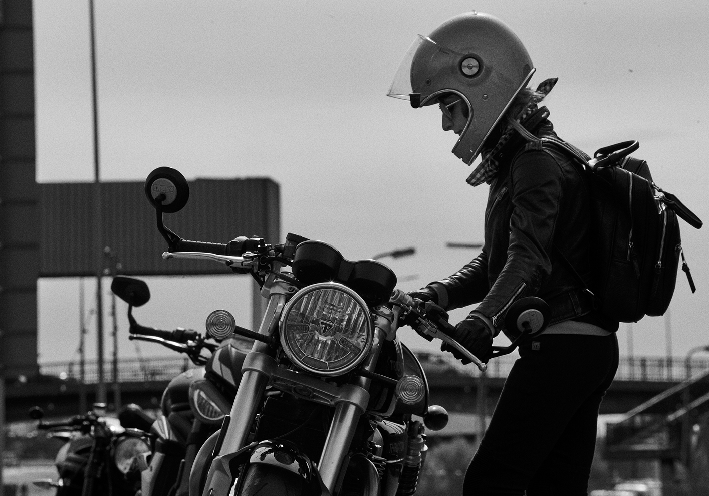 Woman biker riding Triumph Thruxton RS