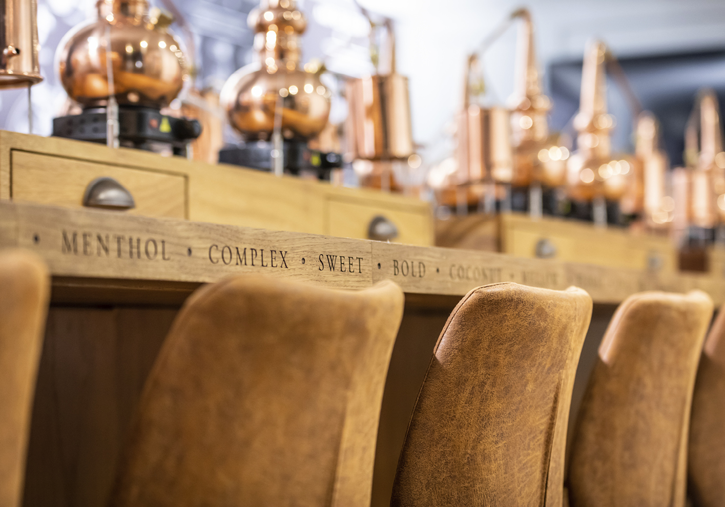 Copper mini stills on the central bench at the London Bridge Distillery School