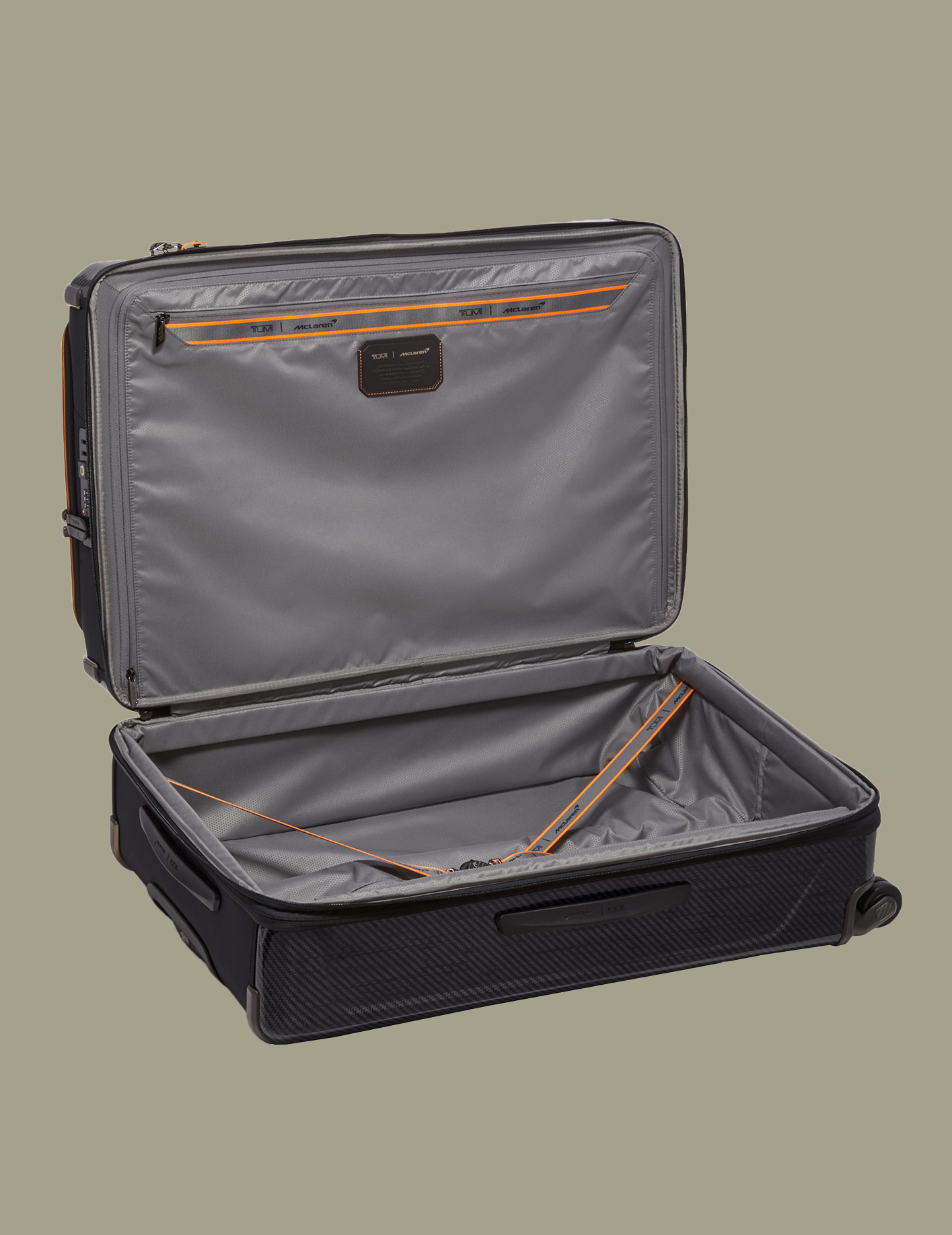 The luggage boasts tones of black and grey with papaya highlights