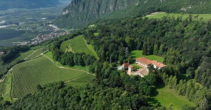Villa Margon, the emblem of Ferrari Trento, nestled beside the hillside vineyards