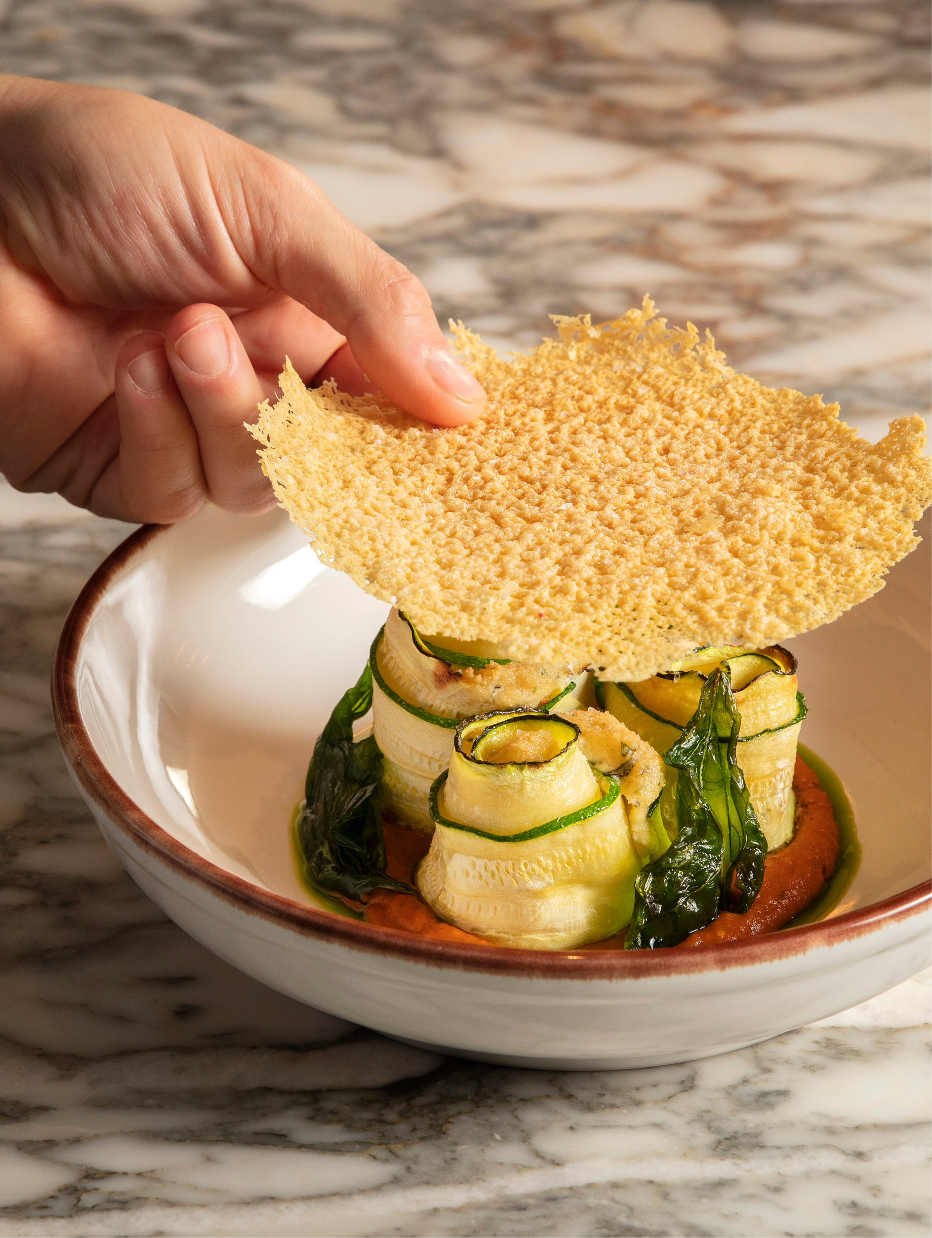 Secondi: Courgette involtini with almond ricotta, winter tomato, basil dusted ‘parmesan’ crisps