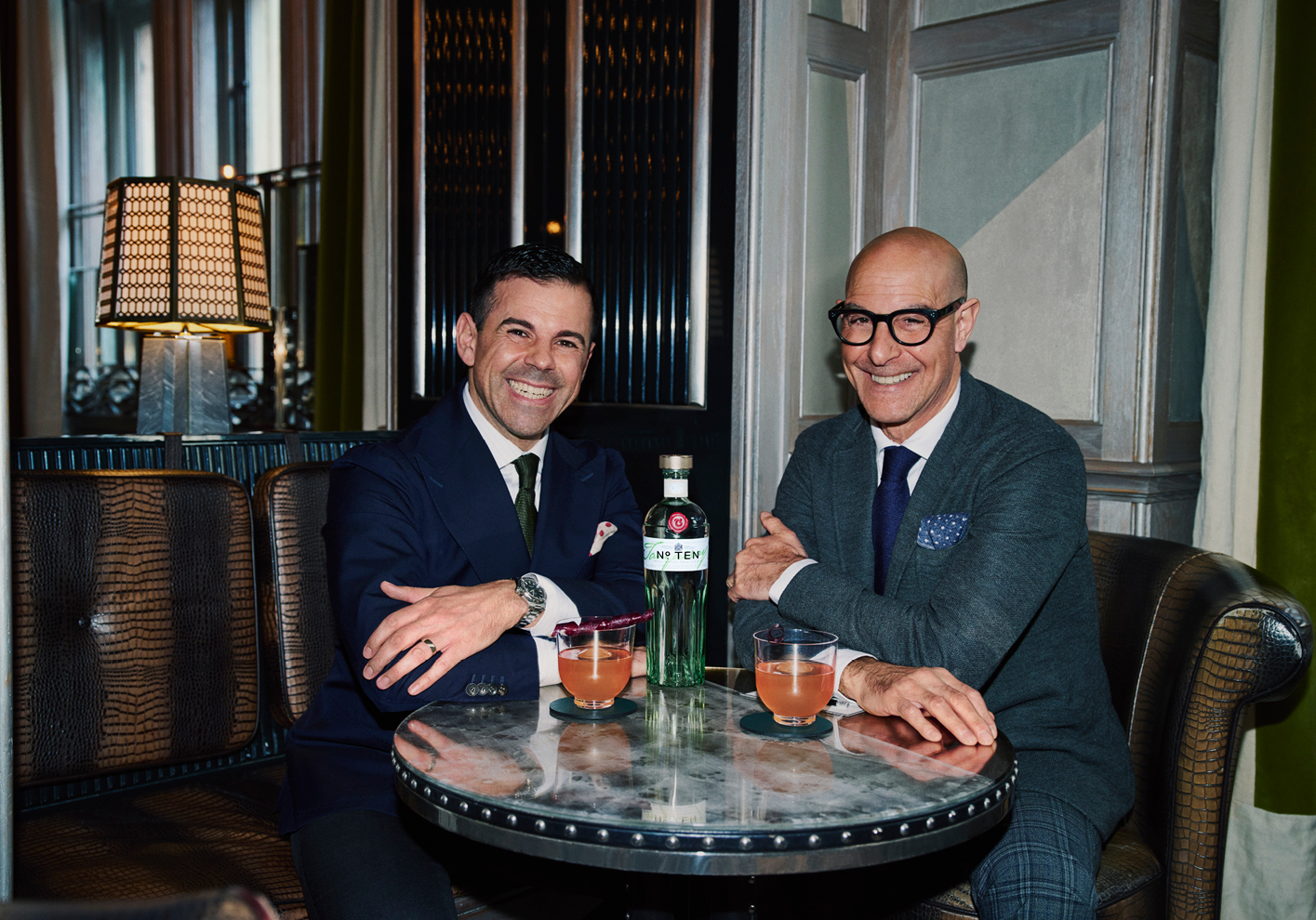 Agostino "Ago" Perrone of the Connaught Bar (left) and Stanley Tucci enjoy the Tenacious cocktail, made using Tanqueray No. 10