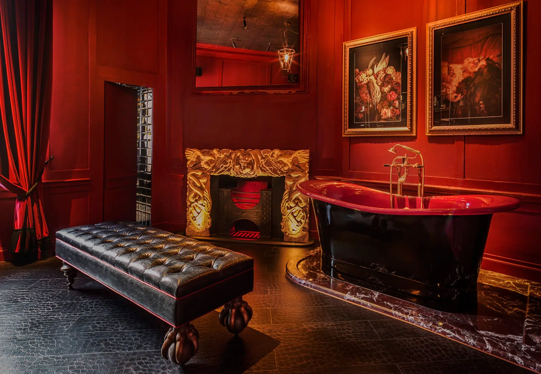 Red panelled room with a free standing bath and leather sofa