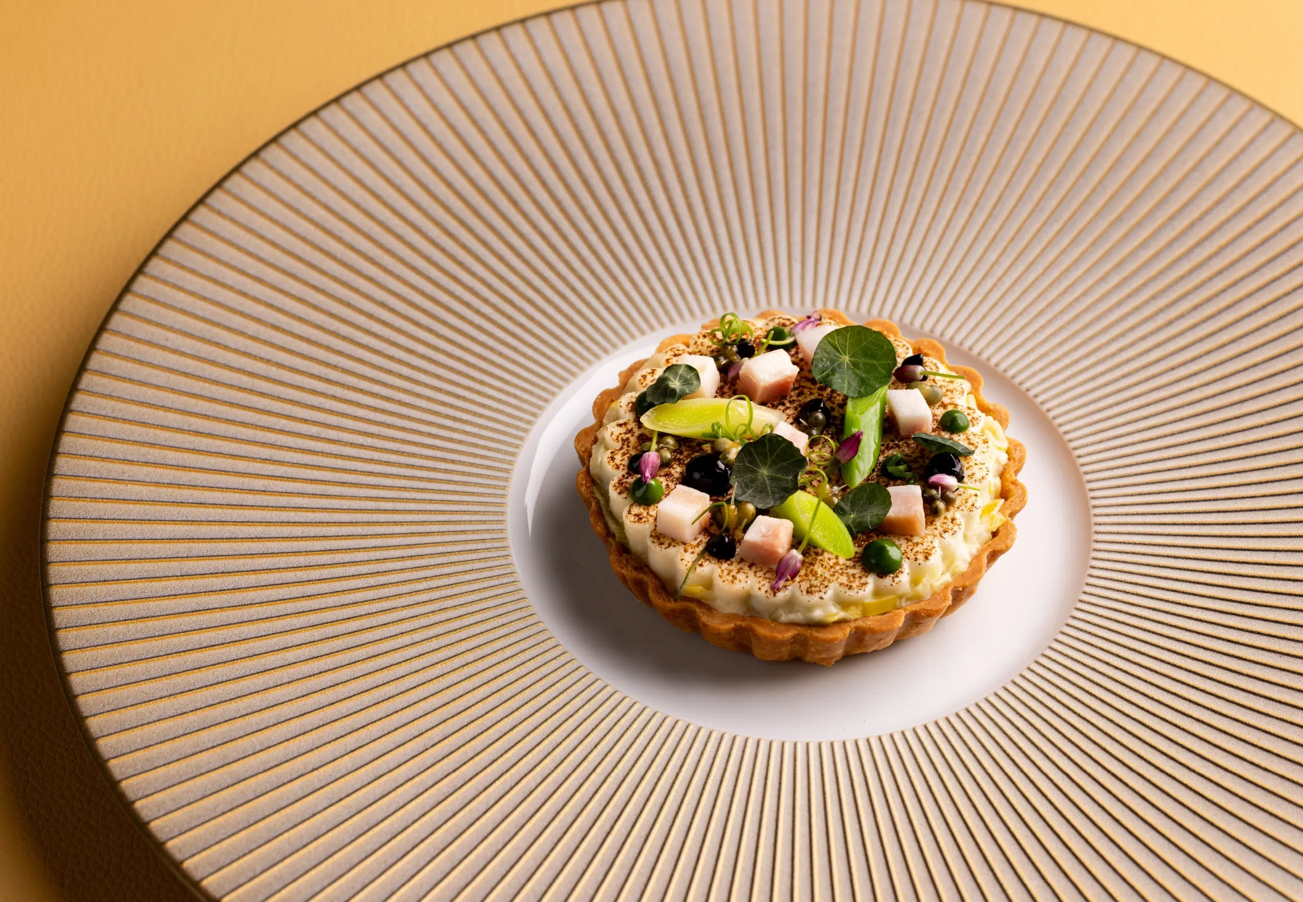 Quiche lorraine on a striped plate