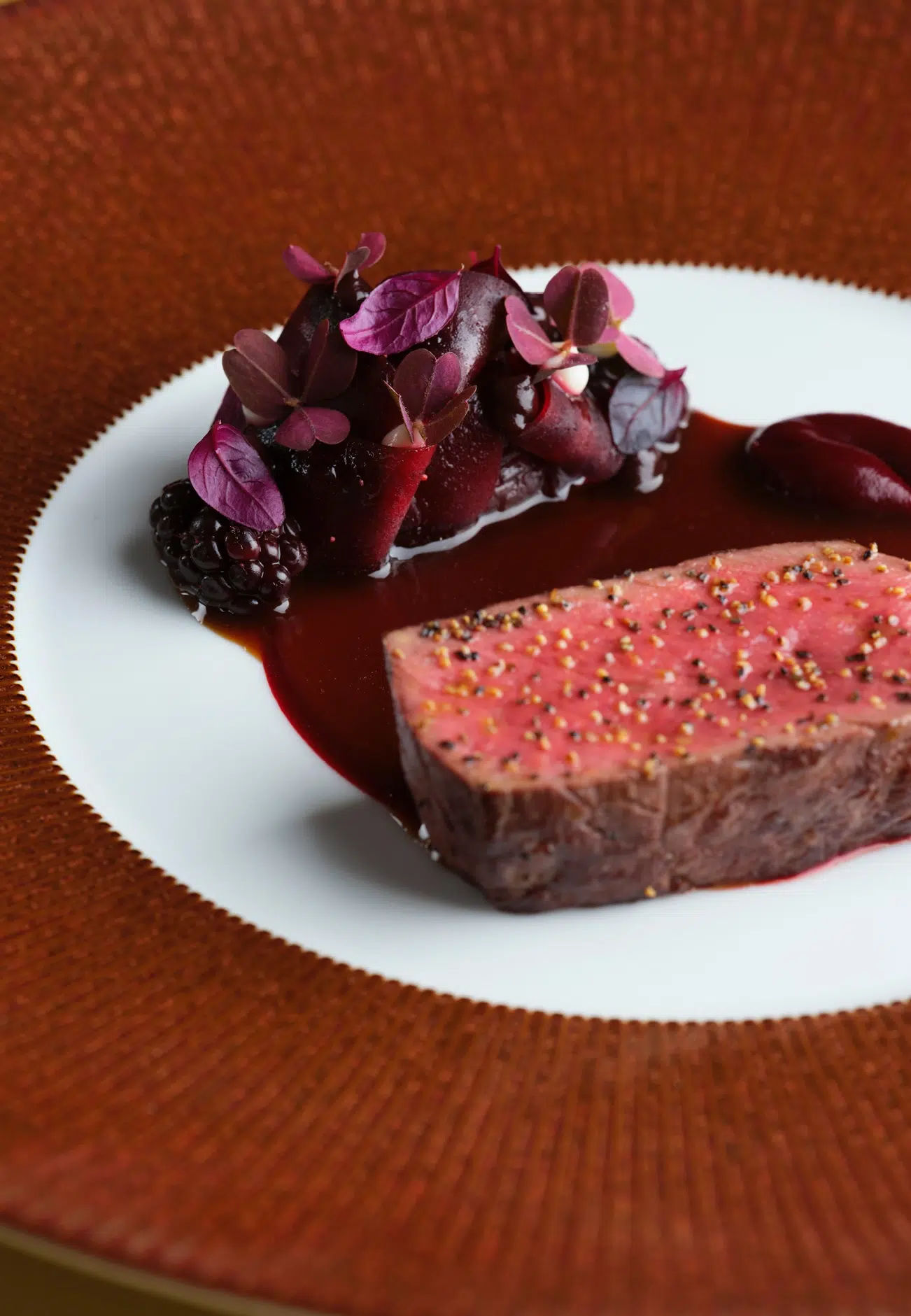 Red venison up close with pickled blackberry