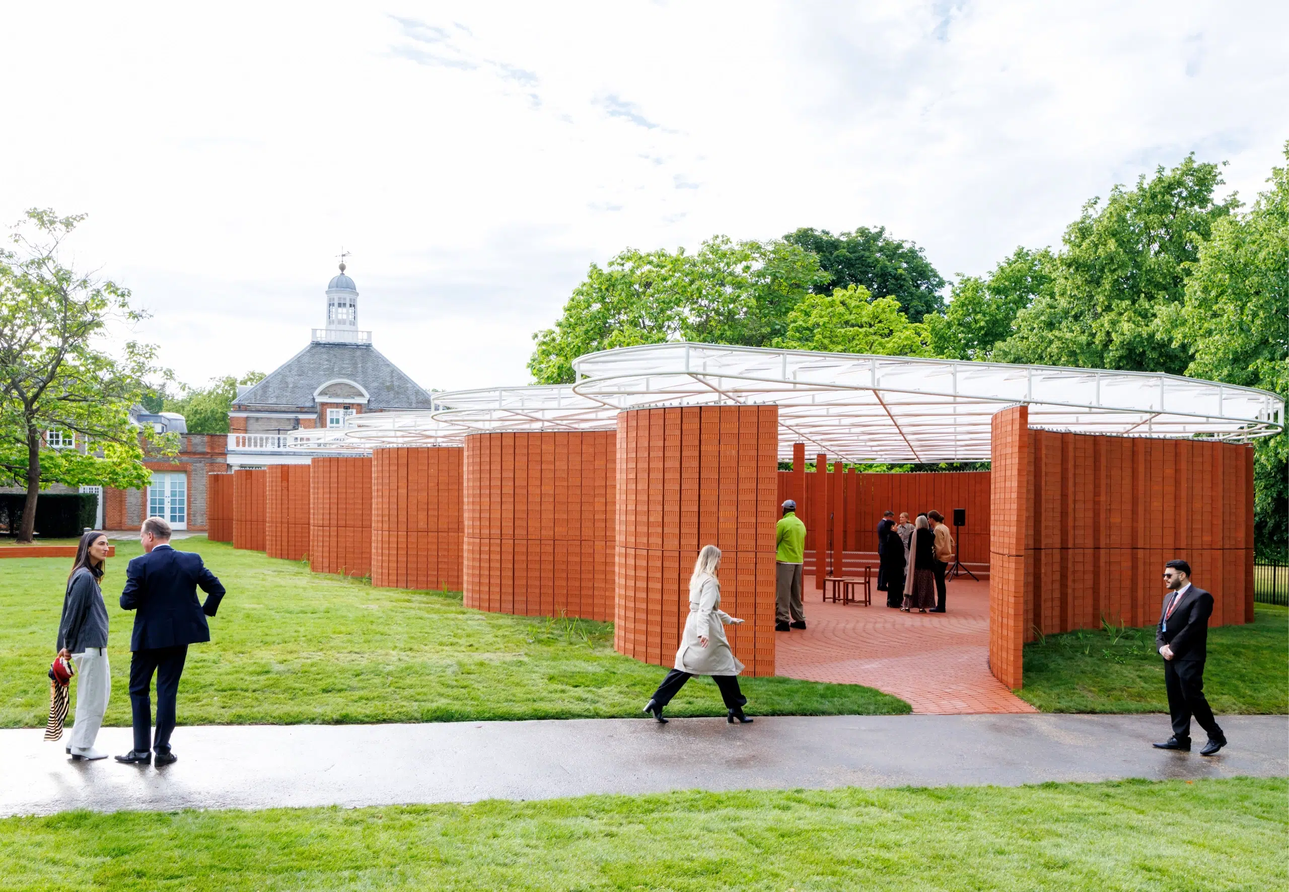 A red brick pavilion in a green park