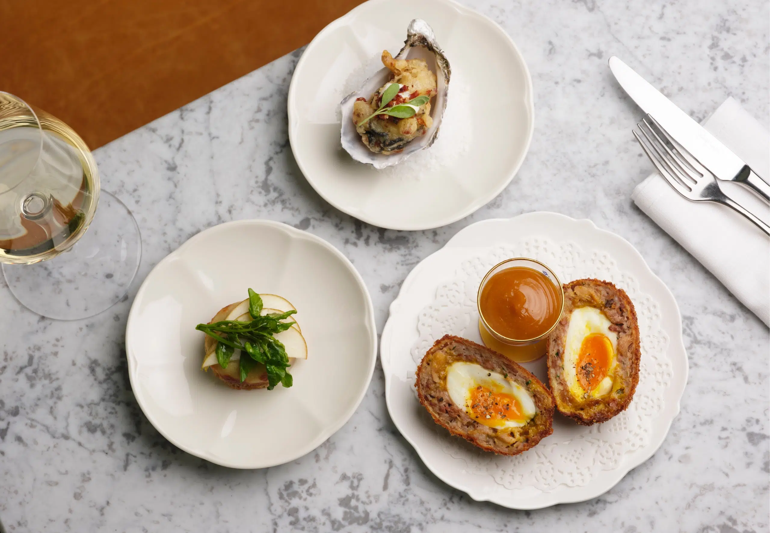 Table with Scotch eggs and angels and devils on horseback